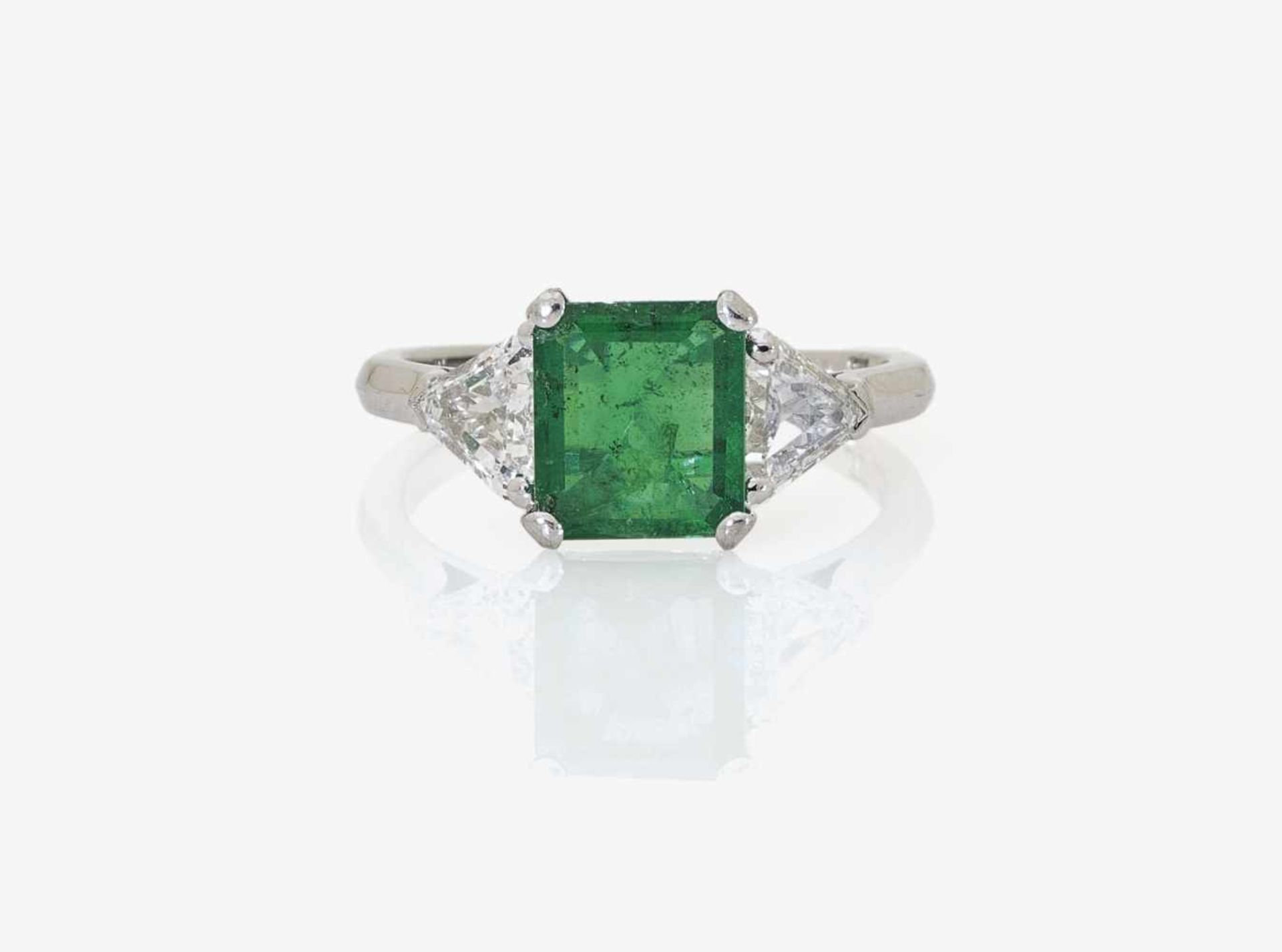 An Emerald and Diamond RingGermany 18K white gold (750/-), stamped. Maker's mark. 2 triangle-cut