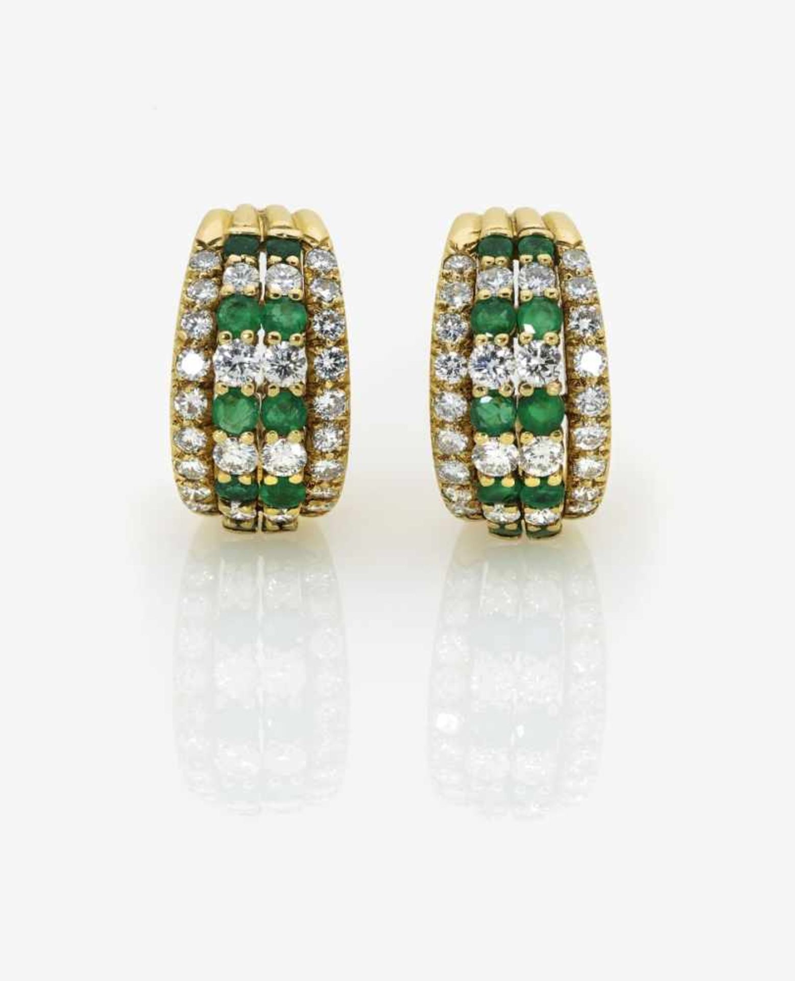 A Pair of Emerald and Diamond Ear ClipsUSA, 1970s-1980s 18K yellow gold (750/-), stamped. 52