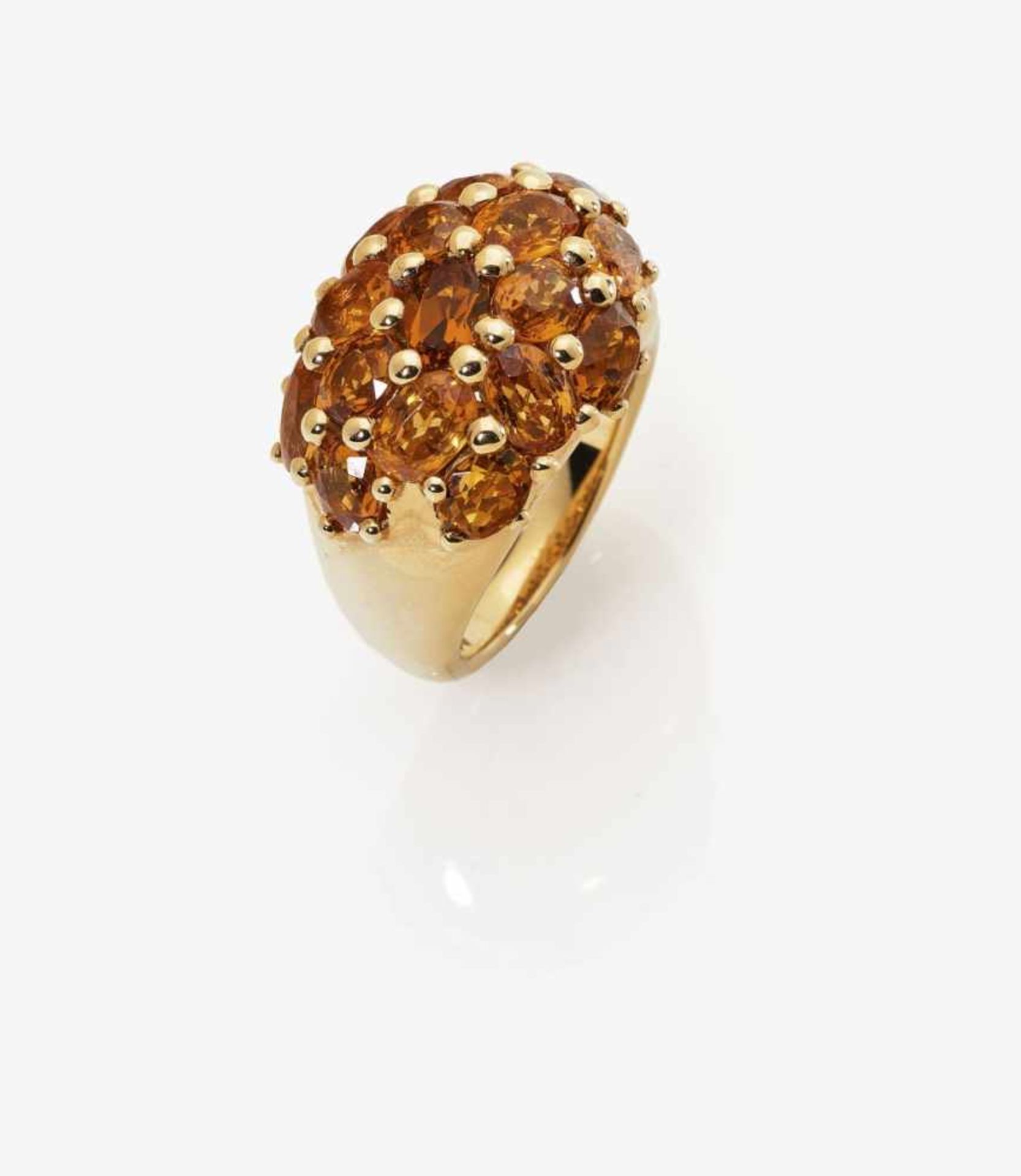 A Mandarin Garnet Ring18K rose gold (750/-), stamped. Maker's mark W. 16 oval, faceted Mandarin