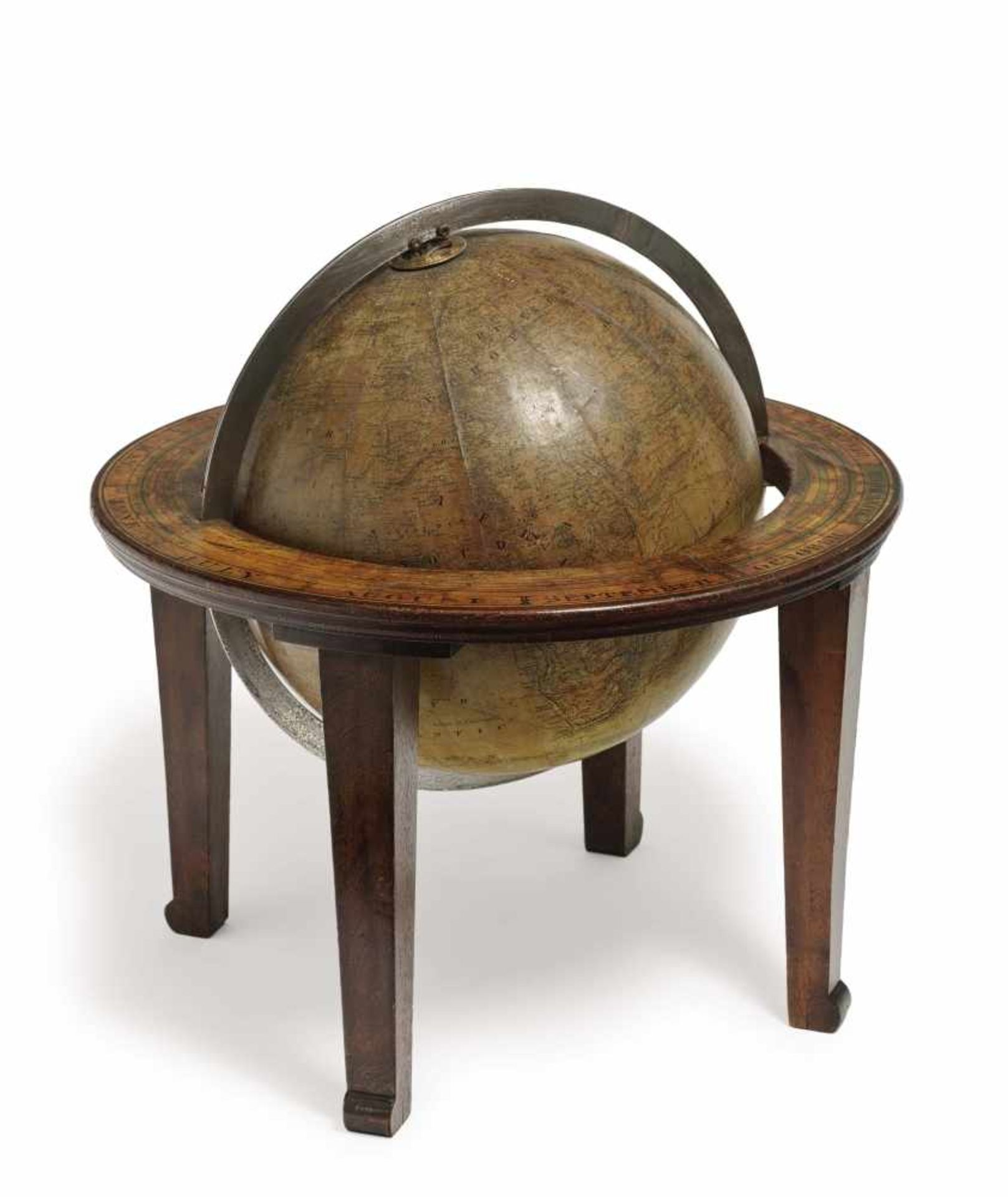 A desktop globeH. Schedler, New York, end of 19th century Wooden frame, brass mounts. Inscribed ''H.