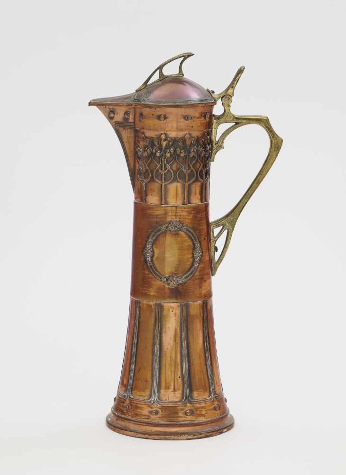 A wine jugWMF, Geislingen, 1904 Copper and brass. Vegetable handle and knob. Floral and ornamental
