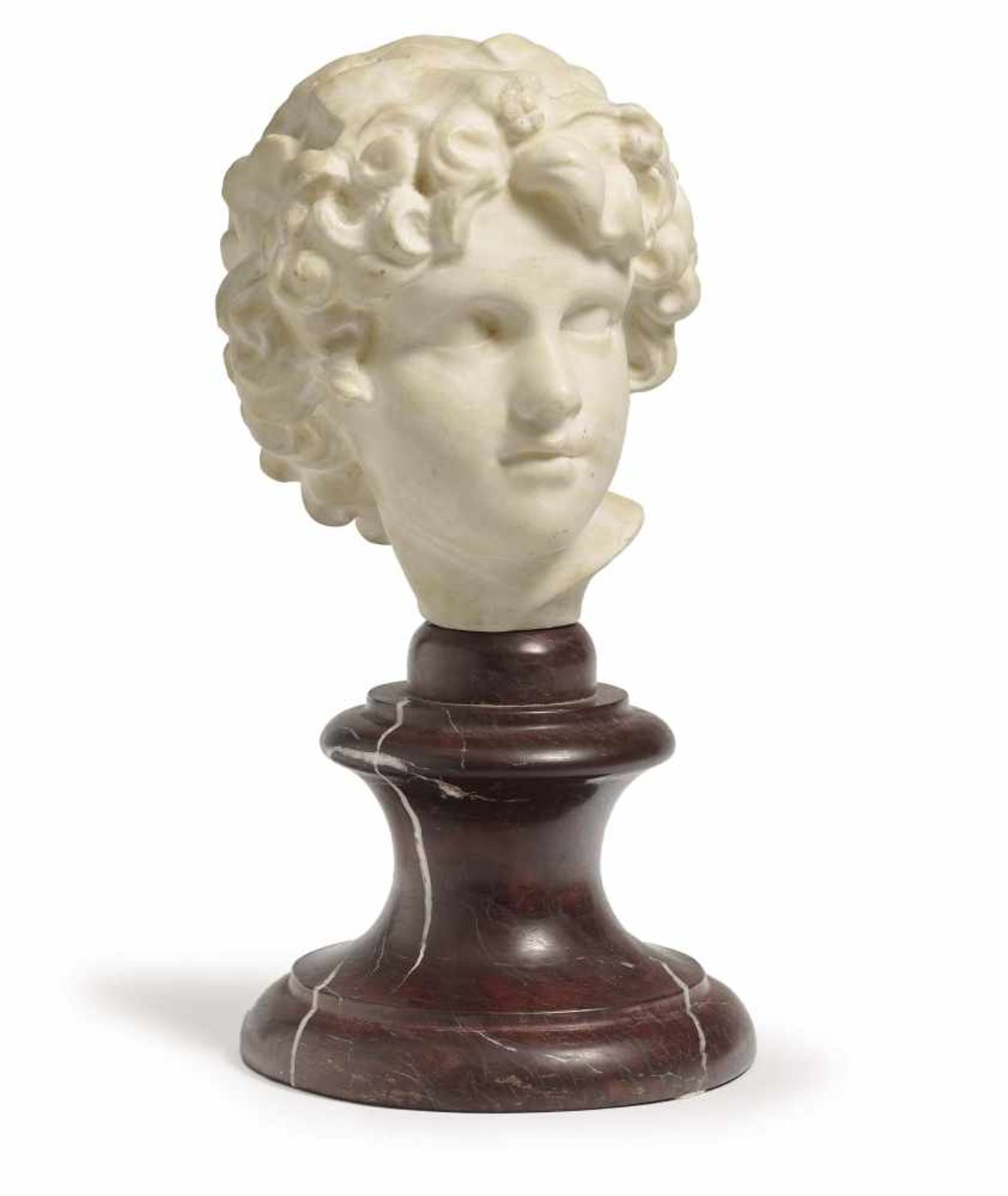 A child's headFrance, circa 1900 White marble. Red marble base. Height (with base) 30 cm.