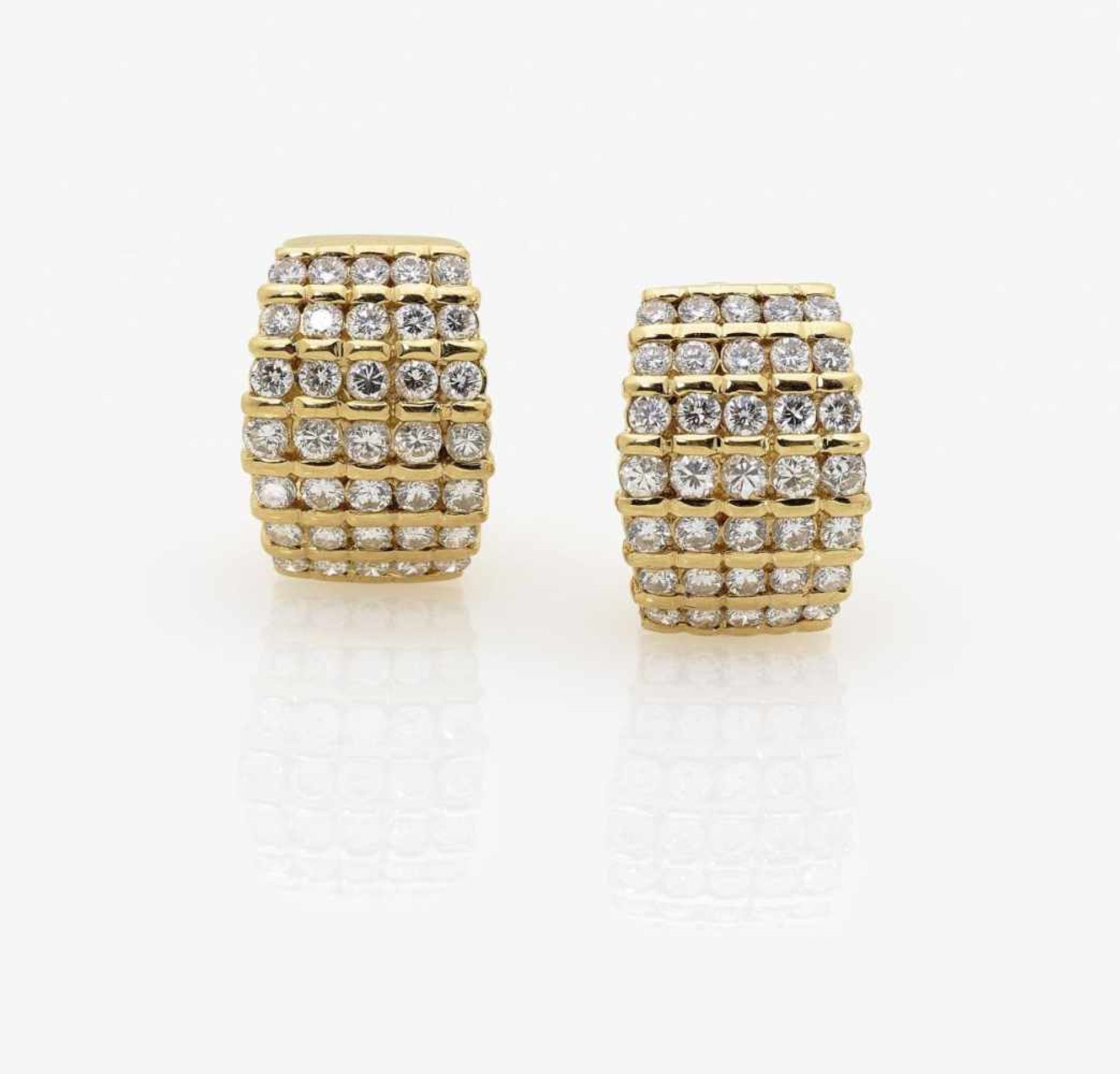 A Pair of Diamond Ear Clips/Studs18K yellow gold (750/-), stamped. Circa 70 brilliant-cut