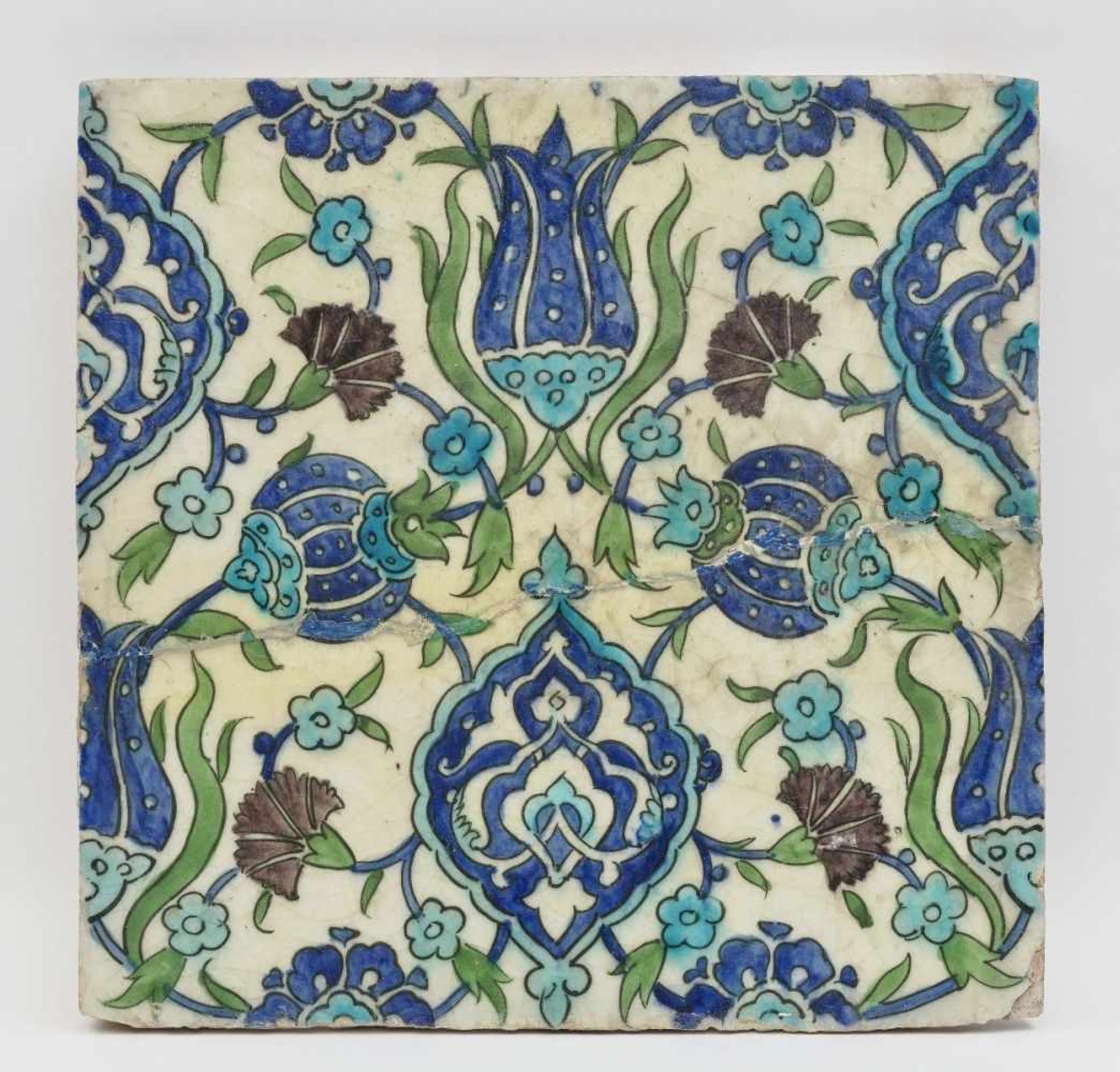 A tileIznik, 17th century Ceramics. Approximately 26.5 cm x 26.5 cm. Restored, bumped. 28 x 28 cm.