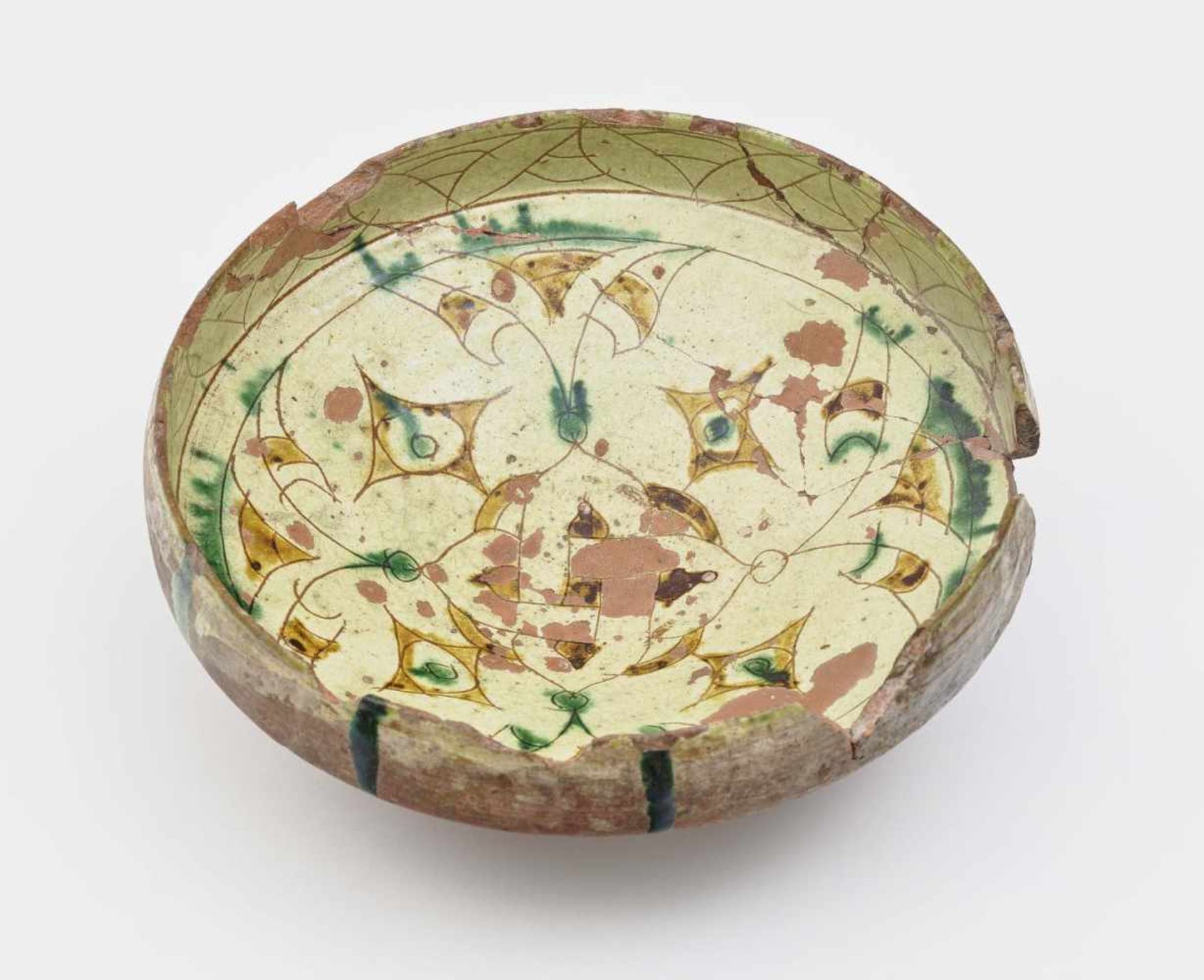 A bowlSoutheast Anatolia, 12th/13th century Earthenware. Carved decor, base coated with white