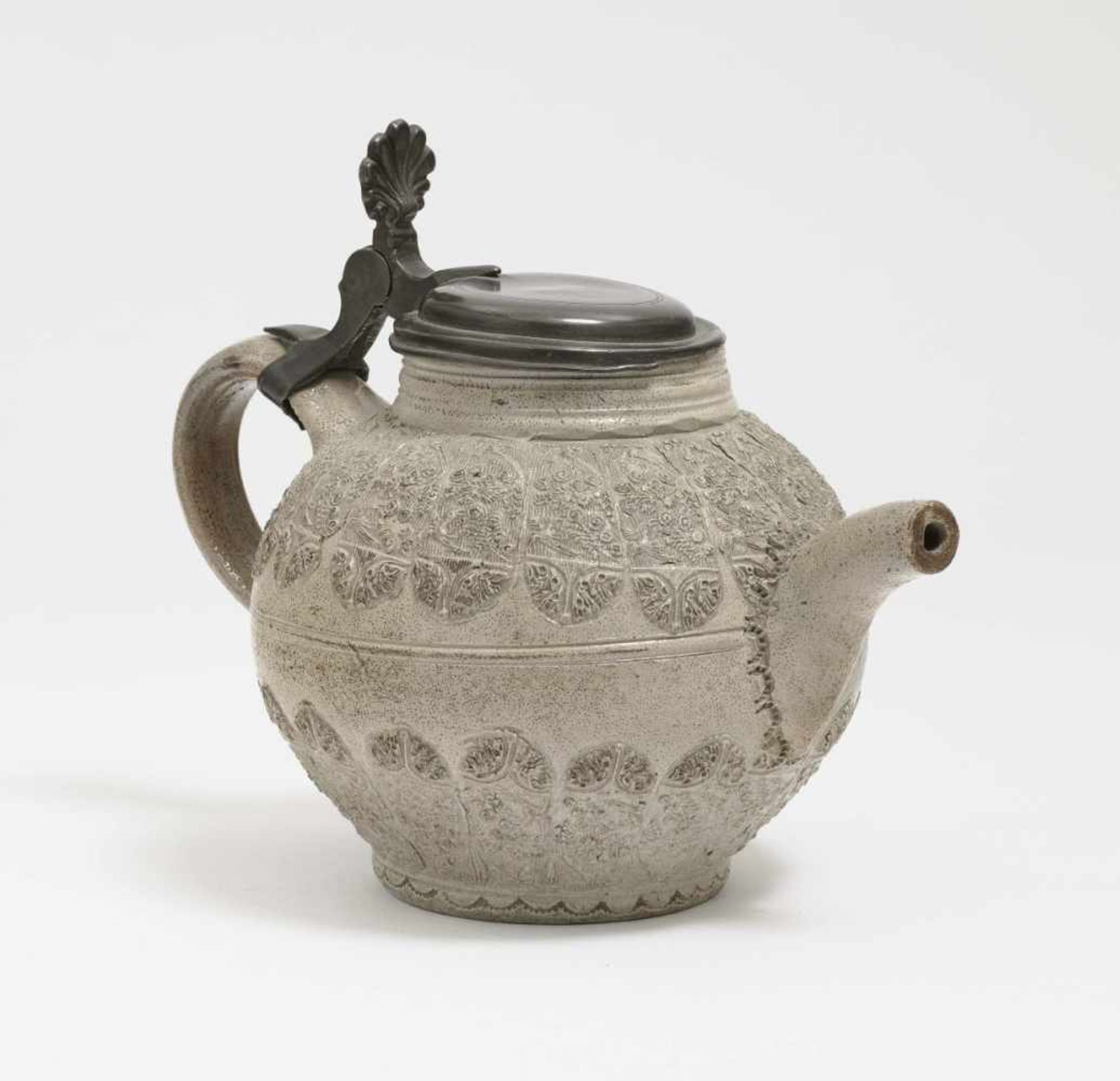 A Tea PotWesterwald, 18th Century Salt-glazed stoneware. Pewter cover. Moulded decoration. Minor
