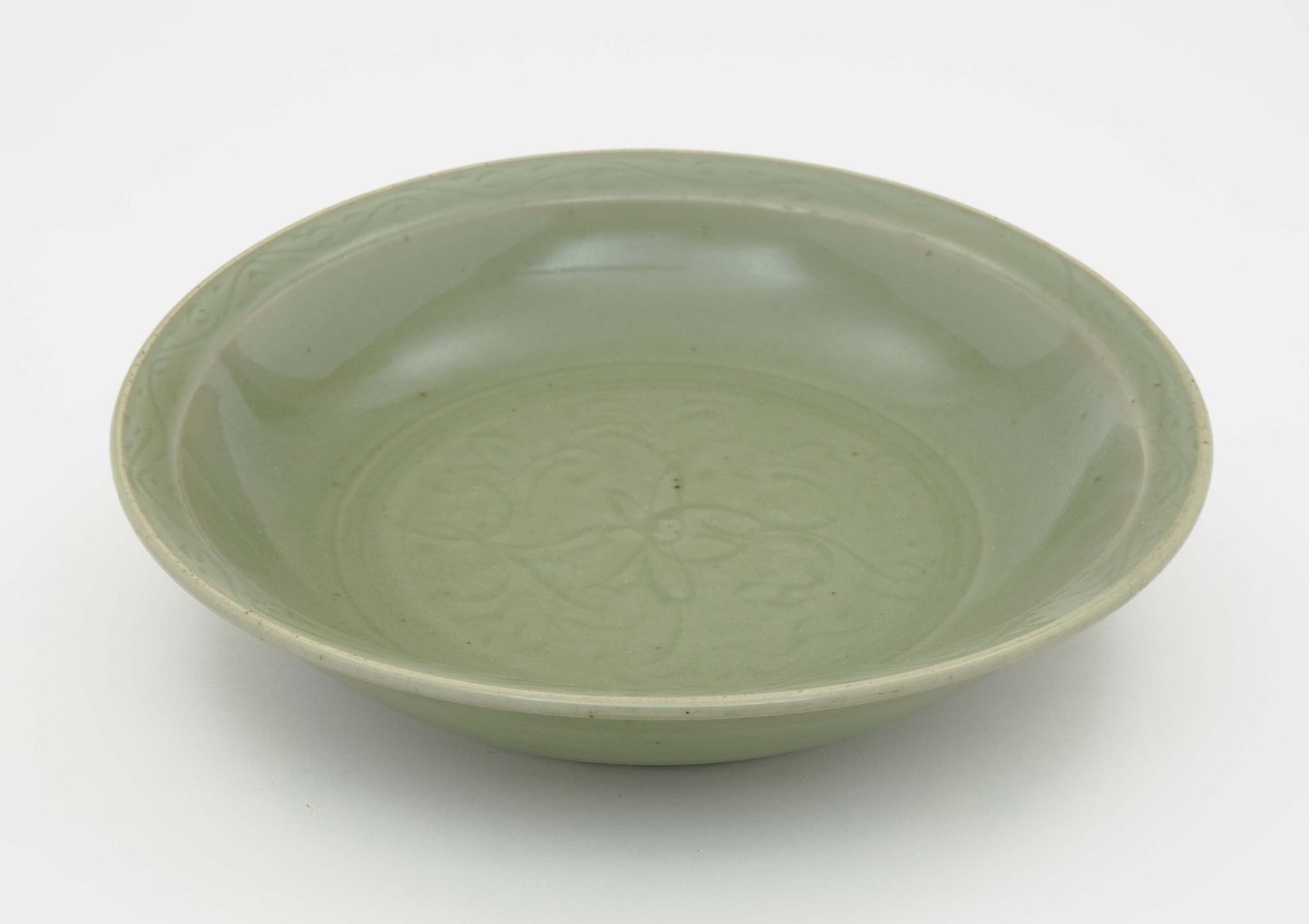 A BowlChina, Qing Porcelain. Celadon glaze. Engraved decor. Diameter 38 cm.China, Tableware,