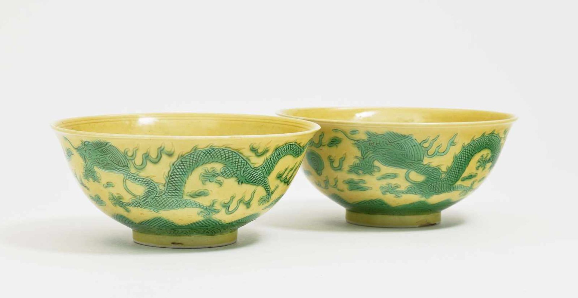 Two Small BowlsChina, Qing Porcelain. Walls and base with incised green dragon decoration. Blue