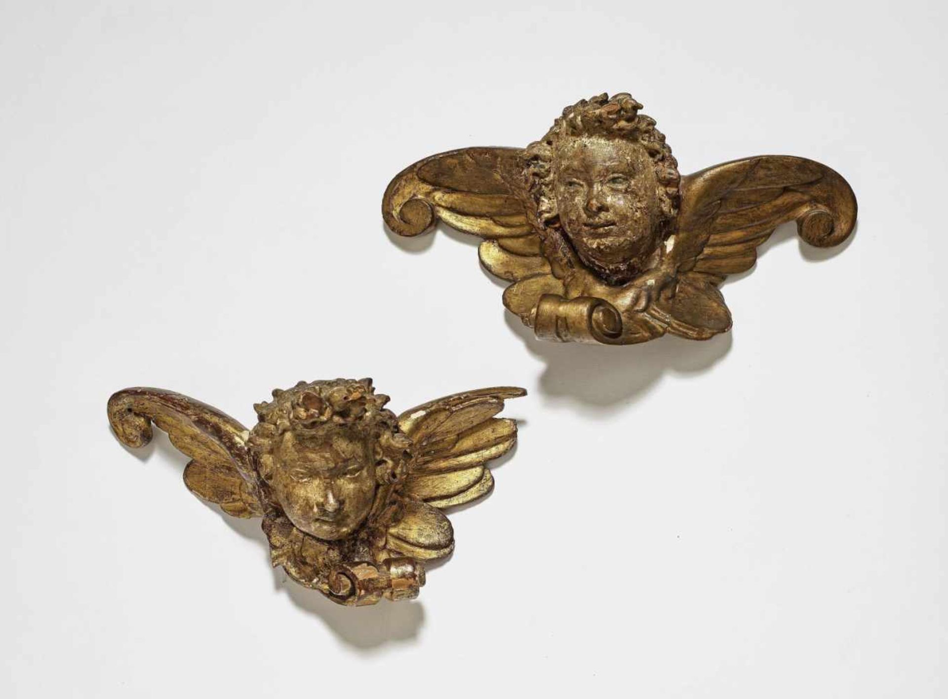 A Pair of Winged Cherub HeadsSouth German, circa 1620 Limewood, reverse flattened. Old polychrome