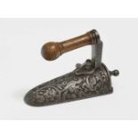 A Miniature IronGerman, 18th Century Iron, wooden handle. Etched decoration. Length 8 cm.Miniatur-