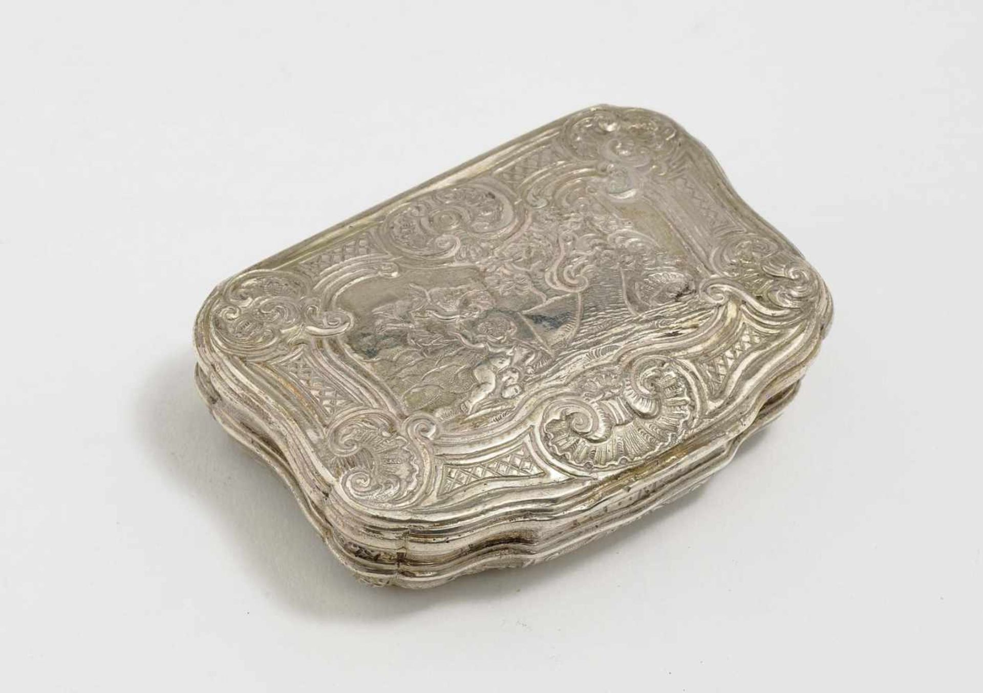 A Snuff Box18th Century Silver, gilt interior. Hammered, chased and embossed decoration. Not
