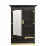 A cupboardVienna, 1905/1910 Oak, black stained. A door with mirror. Hammered brass fittings. Key