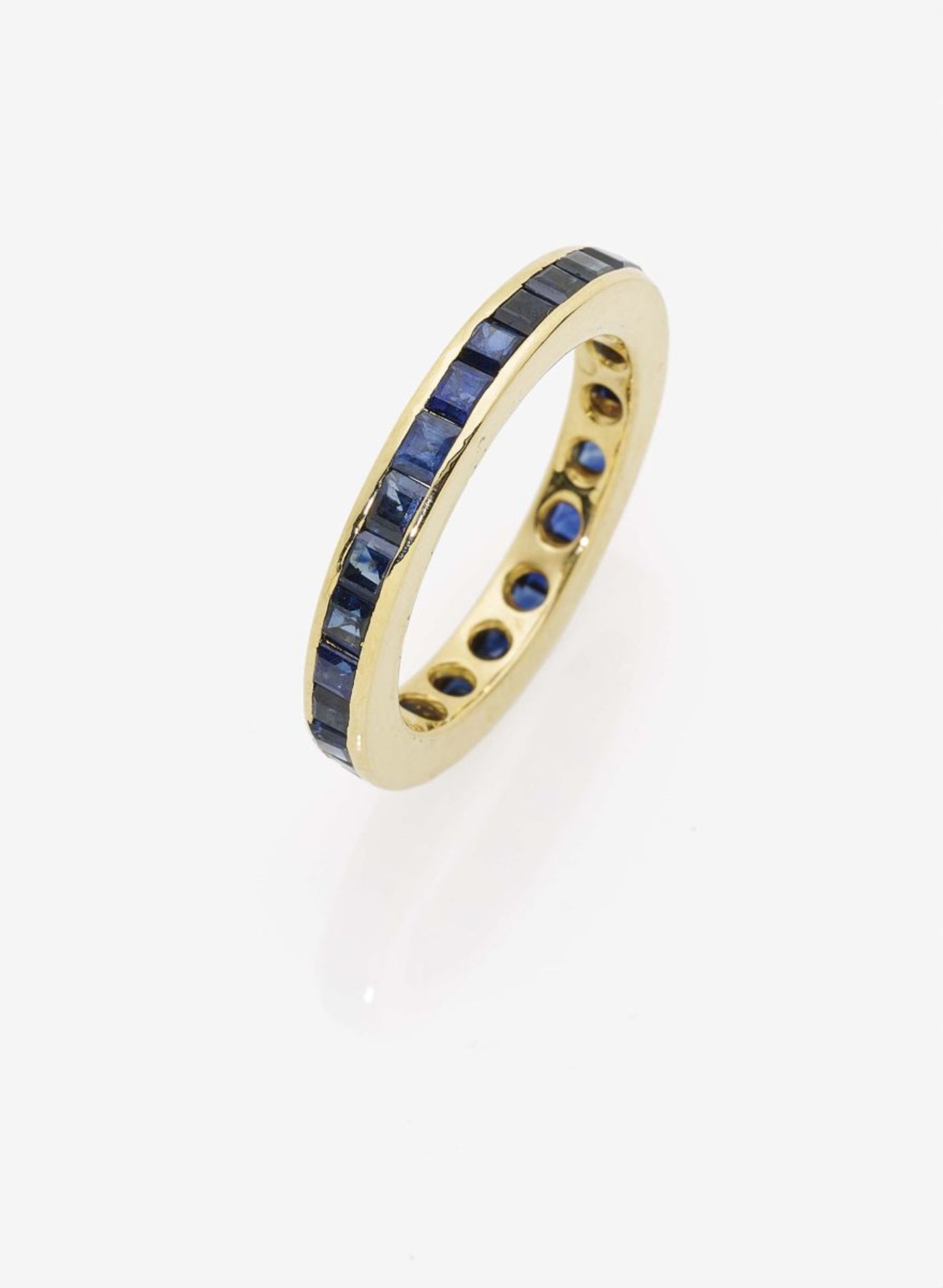 A Blue Sapphire Eternity RingGermany, 1980s 18K yellow gold (750/-), stamped. 29 square, step-cut,