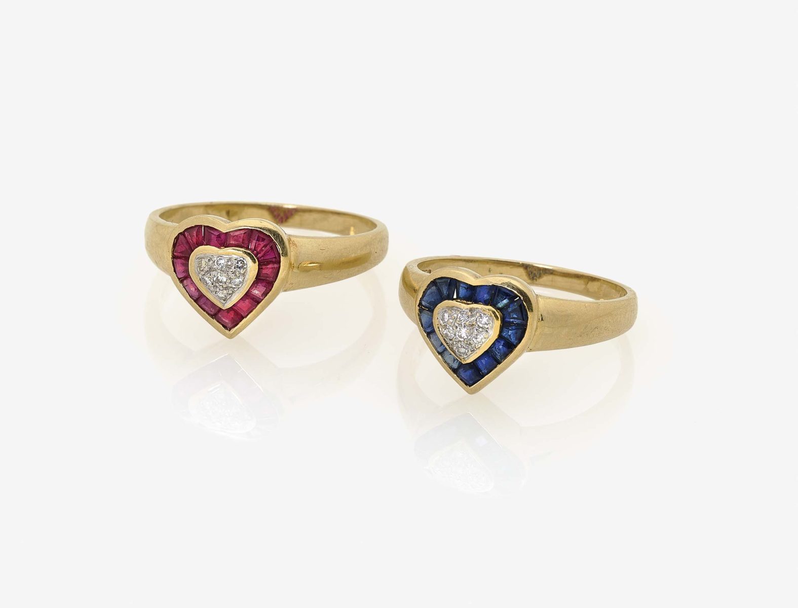 Two Rings set with Diamonds, Rubies and Sapphires18K yellow gold (750/-), stamped. 14 small,