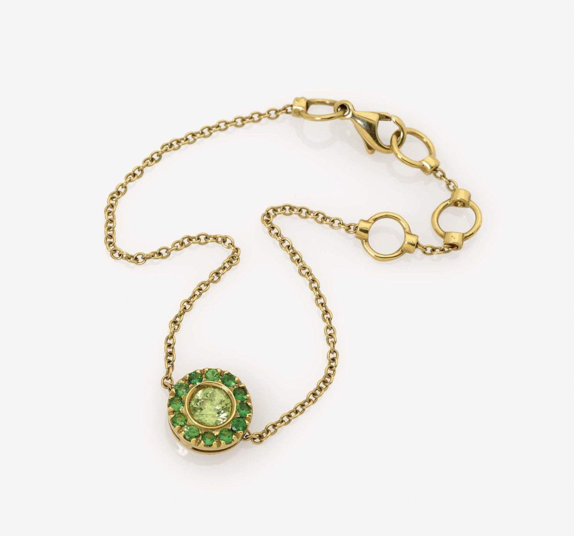 A Peridot and Emerald Bracelet18K yellow gold (750/-), stamped. Maker's marks. 1 brilliant-cut