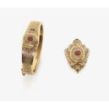 A Bangle and a PendantRussia, circa 1880 14K red gold (585/-), stamped. 2 rectangular rubies,