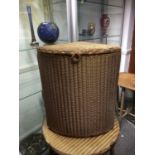 A Lloyd Loom corner laundry basket, gold colouration, paper label to base, 56cm high