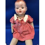 Vintage Doll- A plastic head doll with fabric body and limbs, blue plastic tilt eyes; the head