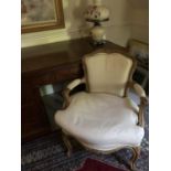 A French walnut salon chair, the frame carved with floral motifs, cream sailcloth upholstered,