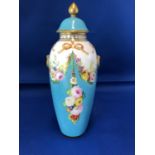 An English porcelain baluster vase and cover, painted with summer flower swags on a turquoise