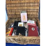 A small Fortnums and Mason wicker hamper, containing various packs of playing cards;m, an Art Deco