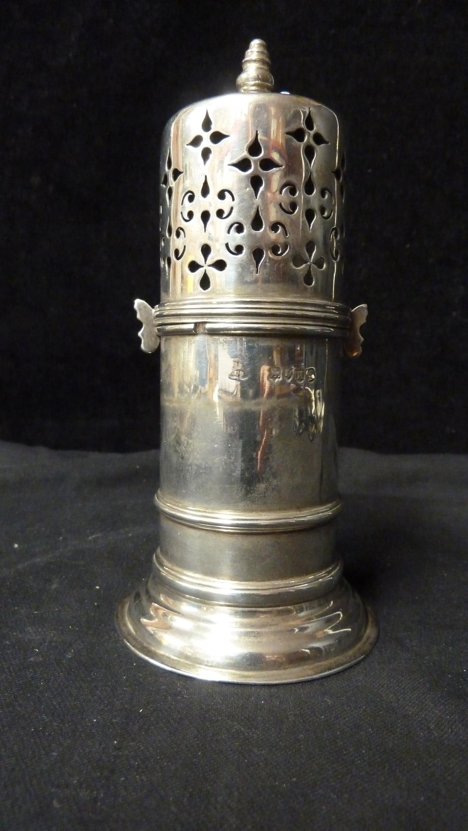 A Silver sugar caster, decorated in Gothic style with foliate 'strapwork' to cover over similar