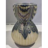 A Loetz Phaenomen glass vase, of gourd form the white body striped on pale gold to the lower section