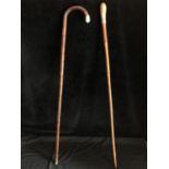 Two silver topped walking canes - one with arched handle the terminal of silver, Birmingham 1908,