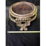 A large gilded gesso vase stand, circular with laurel leaf stretcher and on 'c' scroll feet,