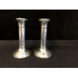 A pair of silver plain column candlesticks, circular bases, Birmingham 1915, makers mark indistinct,