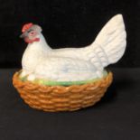 A Staffordshire biscuit porcelain Egg Box and cover, modelled as a hen with eggs nesting in a