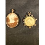 A Victorian double-sided locket, the yellow metal frame set with pendant and bead motifs enclosing