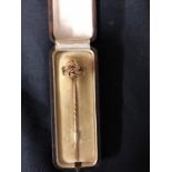 A rose coloured metal Knot tie pin, in fitted case of Aldermann & Sons of Fulham, 7.2cm long (2)
