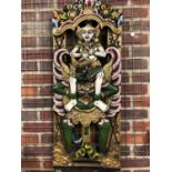 An Indonesian carved and painted wood panel of vishnu riding garuda, polychrome colours with