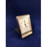 A Cartier 9ct gold 8 day and date Montre de Voyage/ travelling clock, the gold case of rectangular