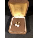 A Pair of 9ct yellow gold and pearl stud earrings, the pearls of rounded cushion form (2)