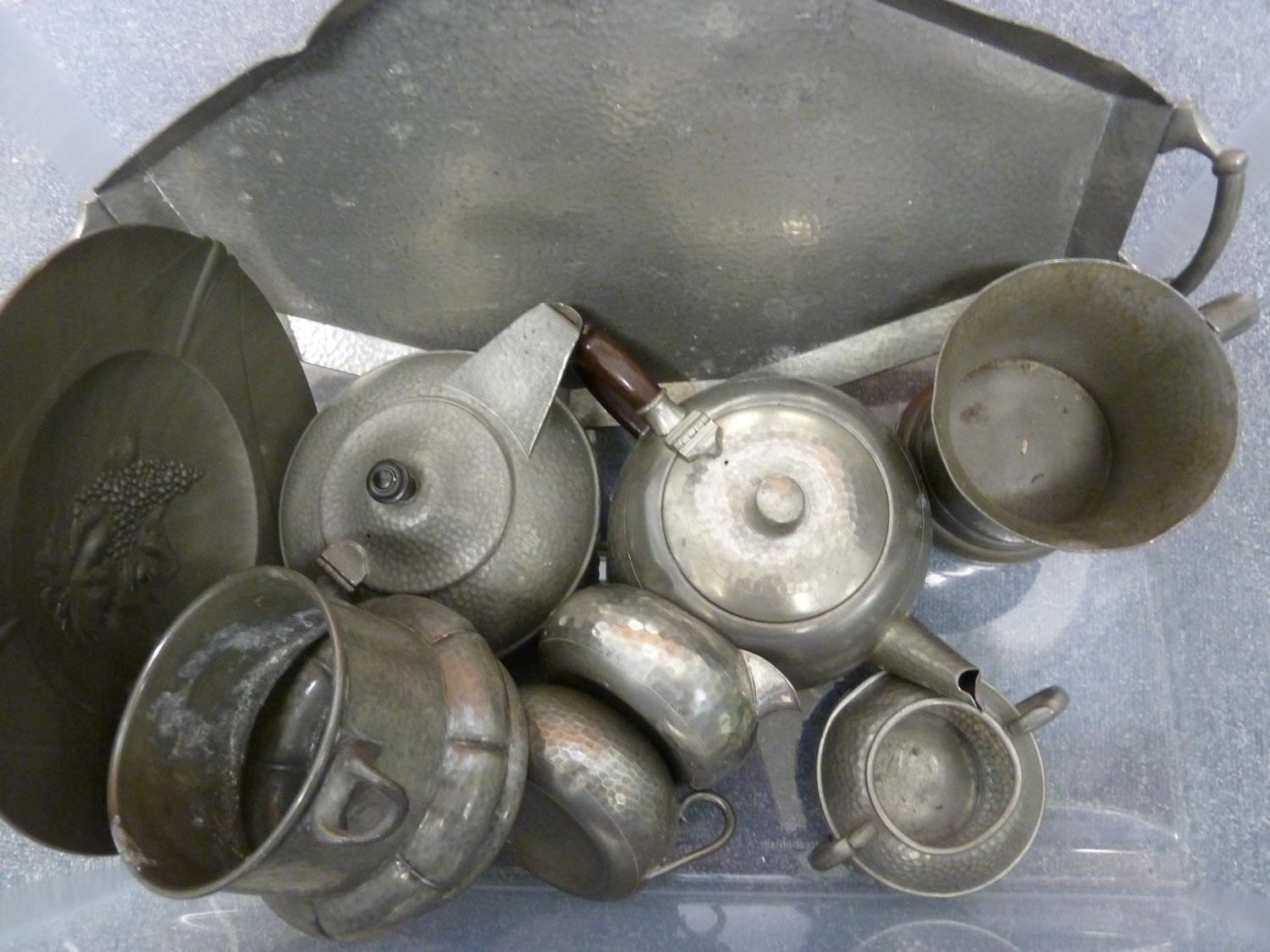 A quantity of pewter wares, including a jardiniere marked Tudric and numbered 01442; tea sets; tea