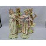 A pair of German biscuit porcelain candlestick figures, of putti with birds; and a pair of a Gallant