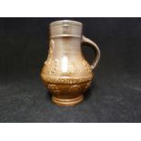 A Saltglaze stoneware bellarmine tankard, with belt and sprigging the belt with motto DRINK:UND: