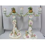 A pair of Meissen porcelain candelabra, each two light with central bouquet finial on rococco stem