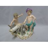 A Meissen Porcelain figure group of two putti with a cannon preparing to fire, polychrome colours,