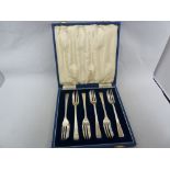 A cased set of six silver cake forks, Sheffield 1965, makers mark F C for Frank Cobb & Co,