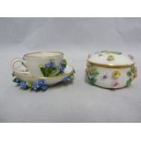 A Meissen porcelain miniature cup and Saucer; and A Meissen porcelain miniature sugar box and cover,