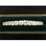 A diamond hinged bangle, consisting of 13 round brilliant cut diamonds, 4.1mm-5.5mm diam, box snap