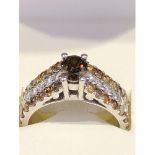 A diamond ring, the central oval cinnamon diamond of 0.6ct approx set within two shoulders of