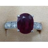 A Burmese ruby and diamond ring, the oval cushion cut ruby weighing a calculated 3.2ct, in four claw