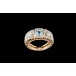 AN AQUAMARINE AND DIAMOND DRESS RING, one cushion cut aquamarine of approx 1.50ct and diamonds of