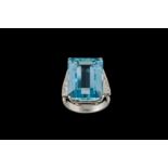 AN AQUAMARINE AND DIAMOND DRESS RING, one rectangular step cut aquamarine of approx. 17.80ct and