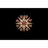 A RUBY AND SEED PEARL STAR BROOCH, mounted in 9ct gold