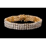 A DIAMOND TRIPLE ROW BRACELET, mounted in yellow gold